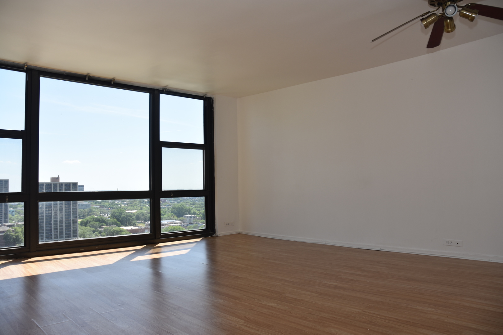 2605 South Indiana Avenue, Unit 2008 Chicago, IL 60616 - Photo 6 of 25 a view of a room with wooden floor and windows