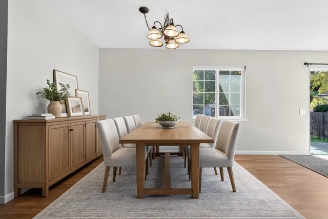a dining room with wooden floor and breakfast area