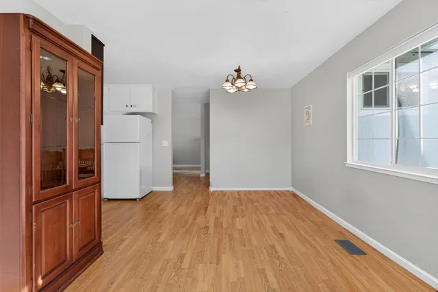 wooden floor in an empty room with a bathroom