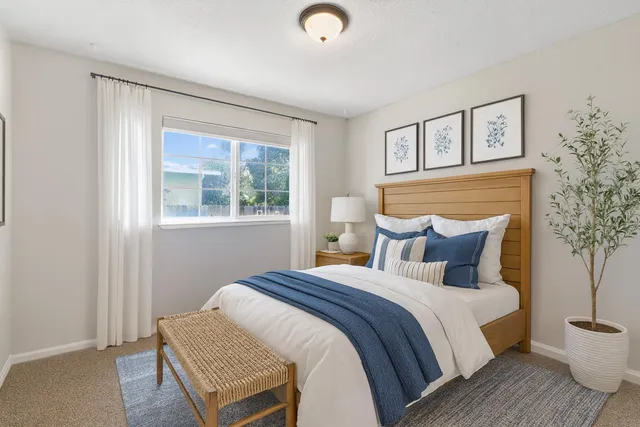 a bedroom with a bed and a window