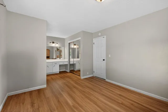 a view of a room with wooden floor and a window