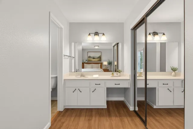 a spacious bathroom with a granite countertop sink a mirror and a shower