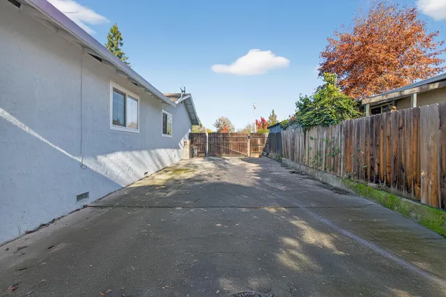 a view of a house with wooden fence