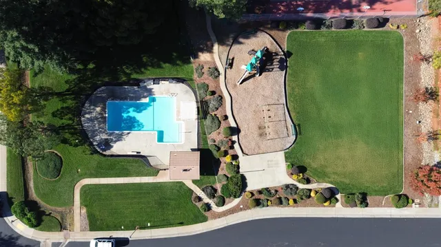 an aerial view of a house with a garden and trees