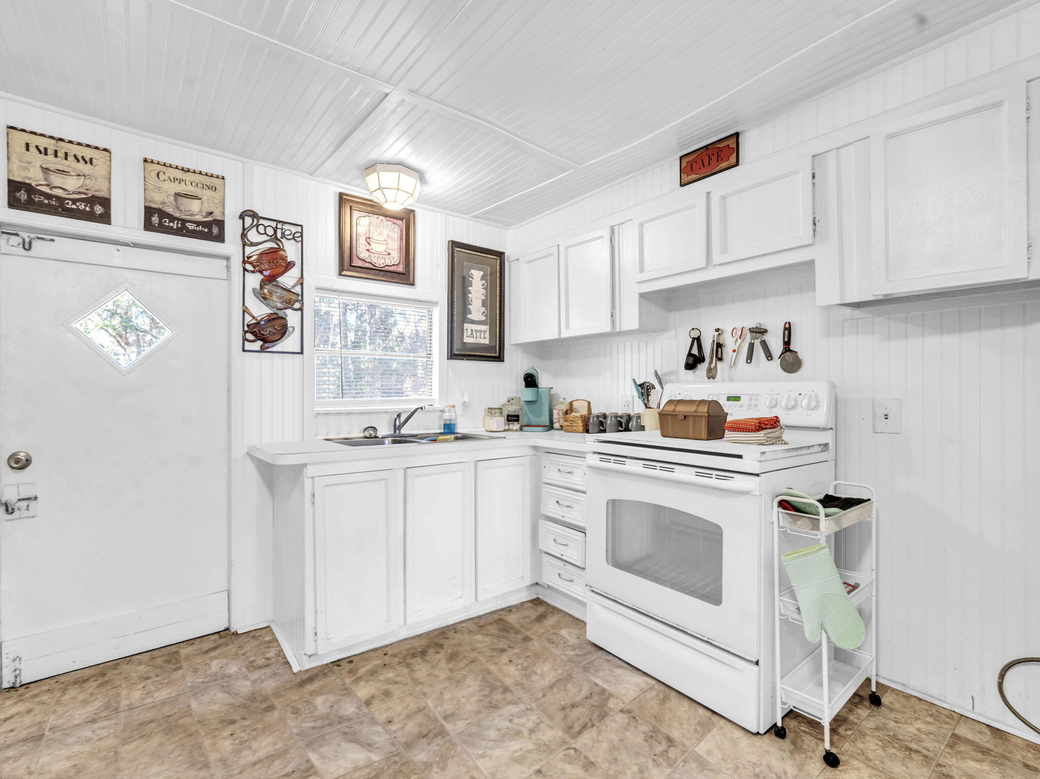 9028 Larker Woods Road Navarre, FL 32566 - Photo 13 of 36 a kitchen with granite countertop white cabinets and white appliances