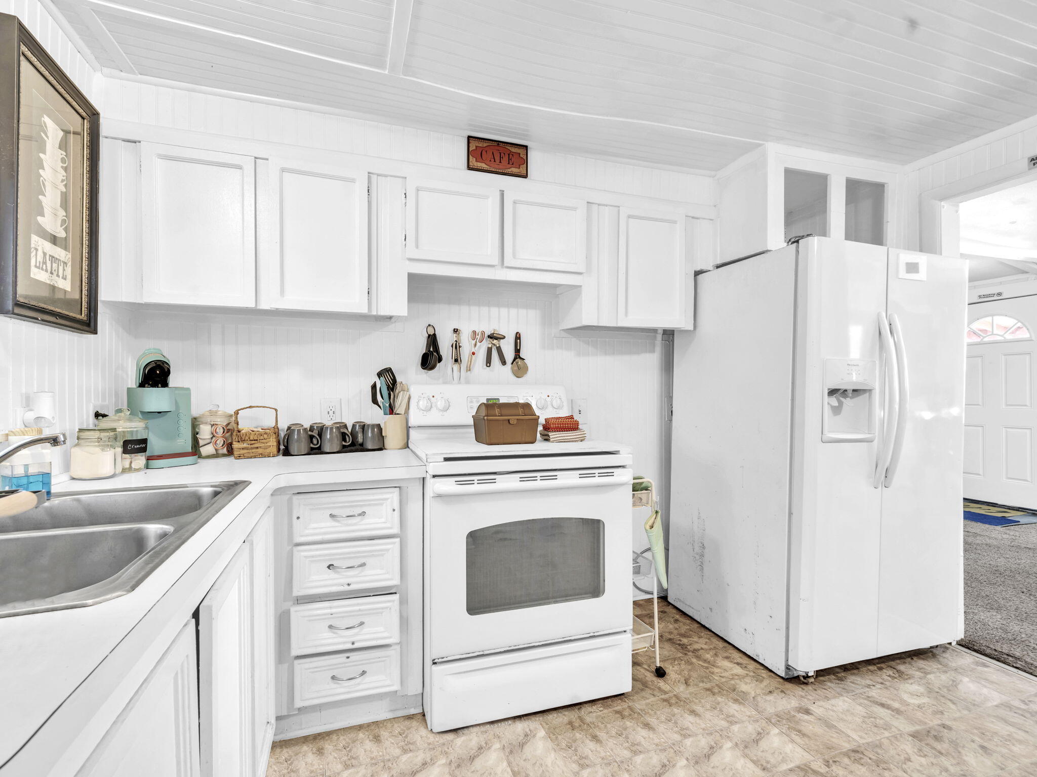 9028 Larker Woods Road Navarre, FL 32566 - Photo 14 of 36 a kitchen with cabinets stainless steel appliances and sink