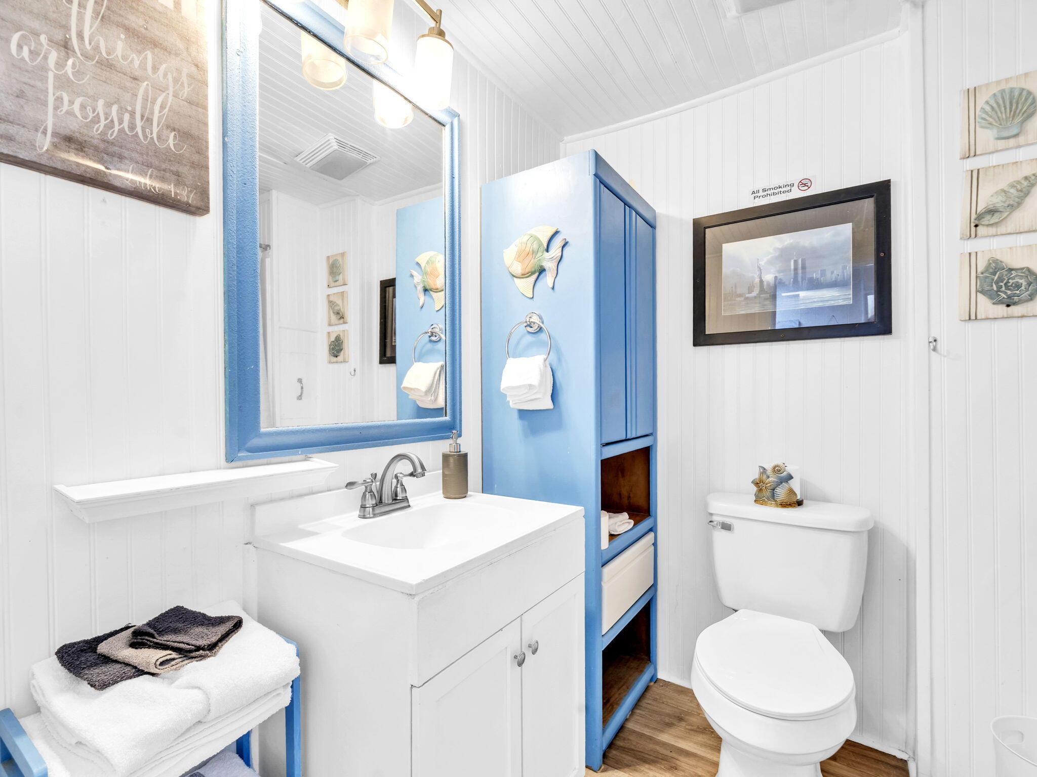 9028 Larker Woods Road Navarre, FL 32566 - Photo 19 of 36 a bathroom with a toilet a sink and a mirror