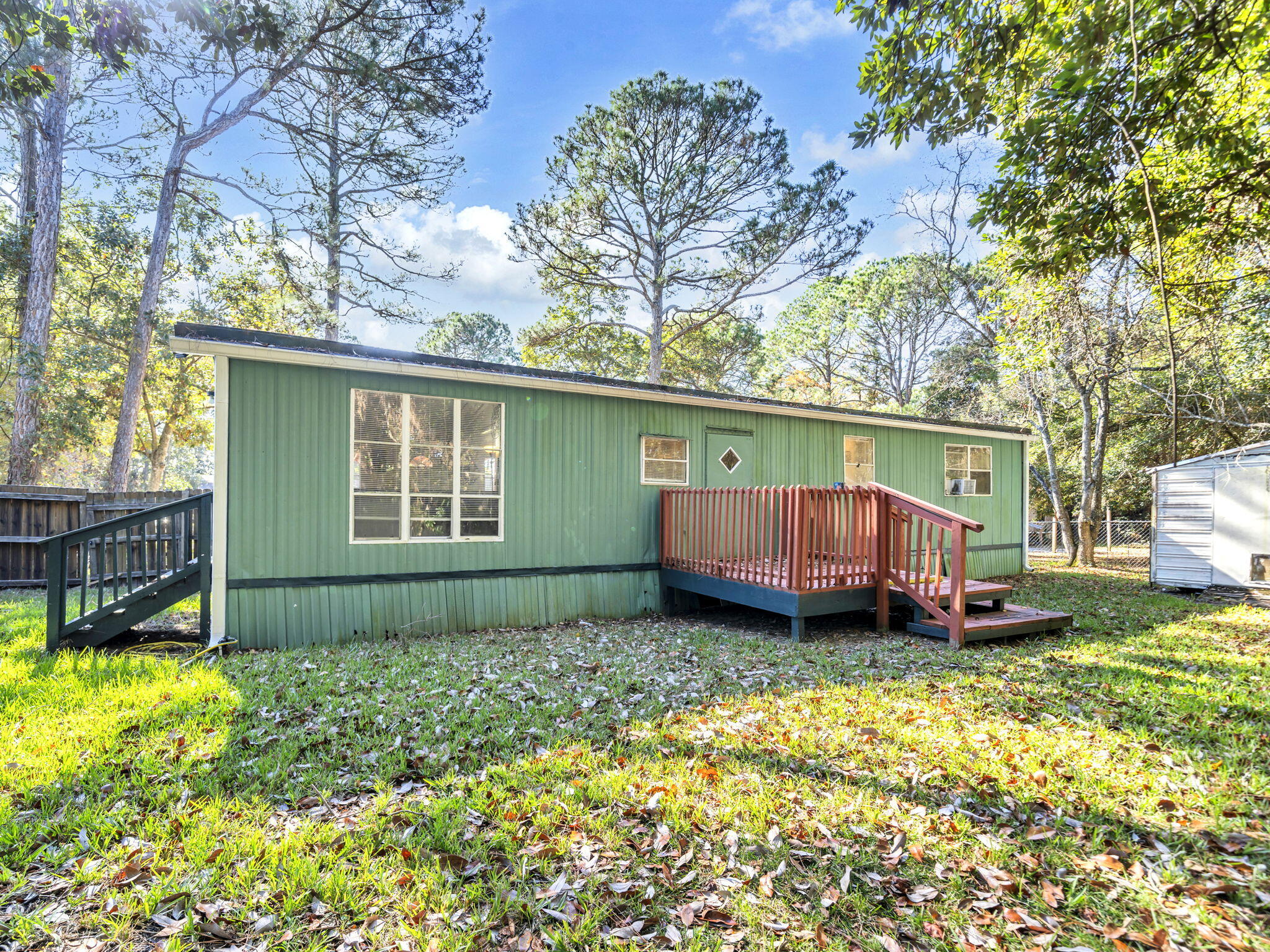 9028 Larker Woods Road Navarre, FL 32566 - Photo 31 of 36 a view of a house with a yard and furniture