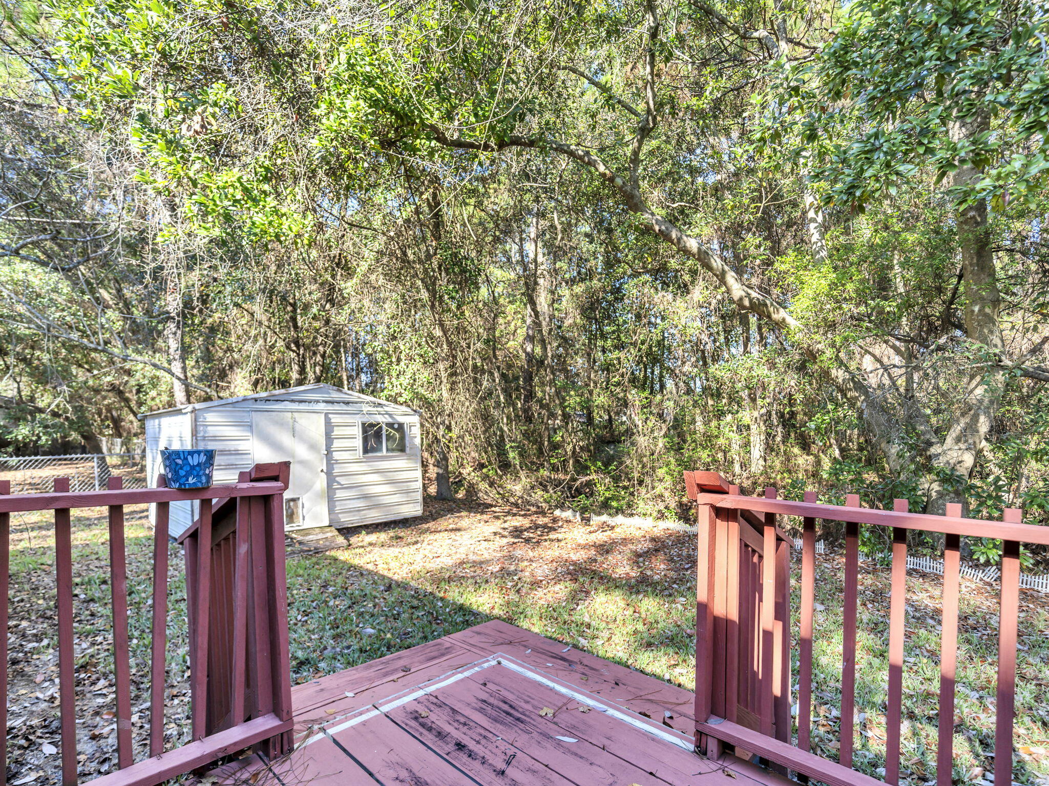 9028 Larker Woods Road Navarre, FL 32566 - Photo 32 of 36 a view of a deck with a yard
