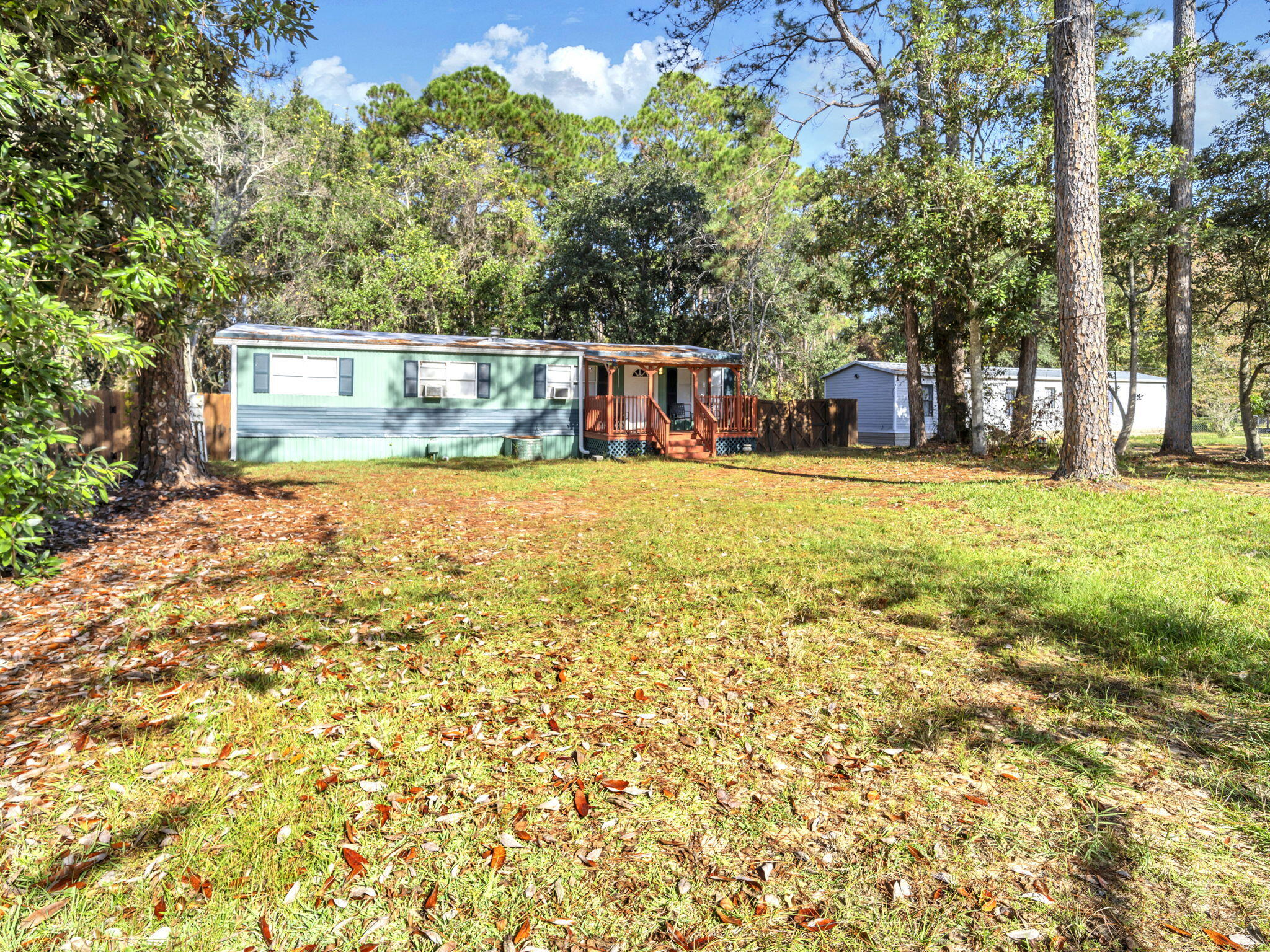 9028 Larker Woods Road Navarre, FL 32566 - Photo 5 of 36 a front view of a house with a garden