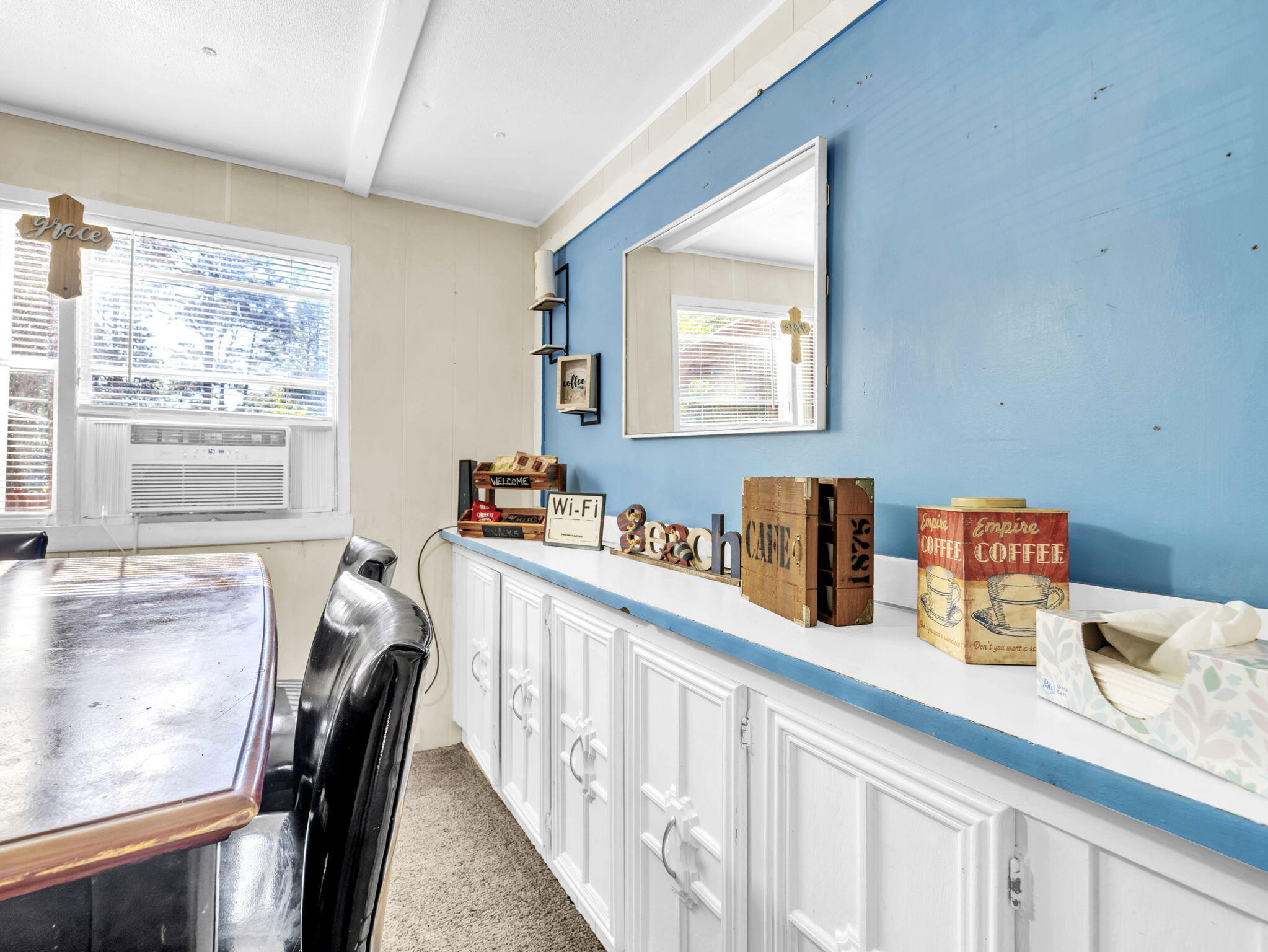 9028 Larker Woods Road Navarre, FL 32566 - Photo 10 of 36 a kitchen with stainless steel appliances granite countertop a stove a sink a dining table and chairs with wooden floor