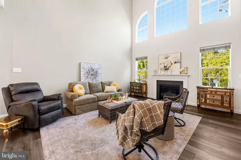 a living room with furniture fireplace and a table