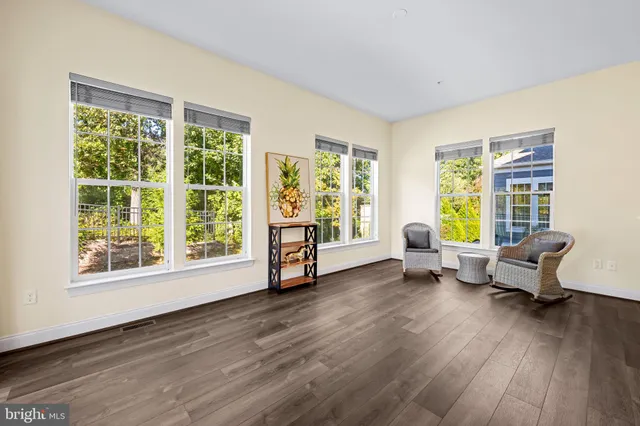 a view of kitchen with wooden floor and electronic appliances