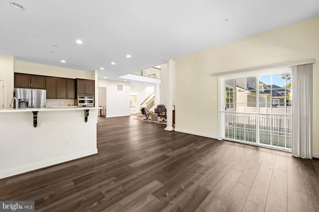 a kitchen with stainless steel appliances a stove a sink a microwave a refrigerator and cabinets