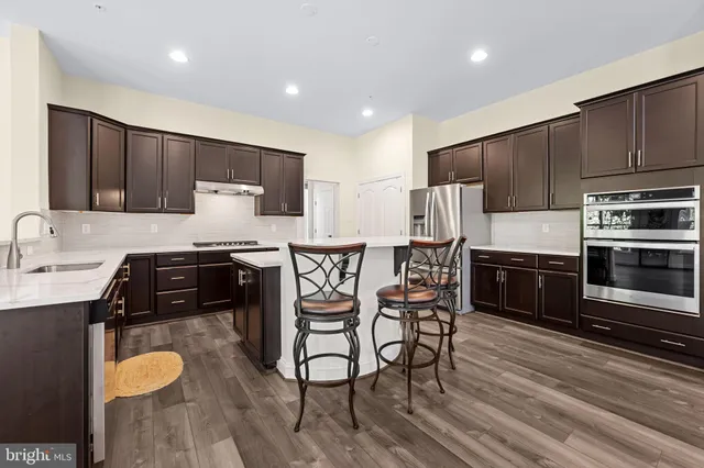 a view of a dining room with furniture and a wooden floor