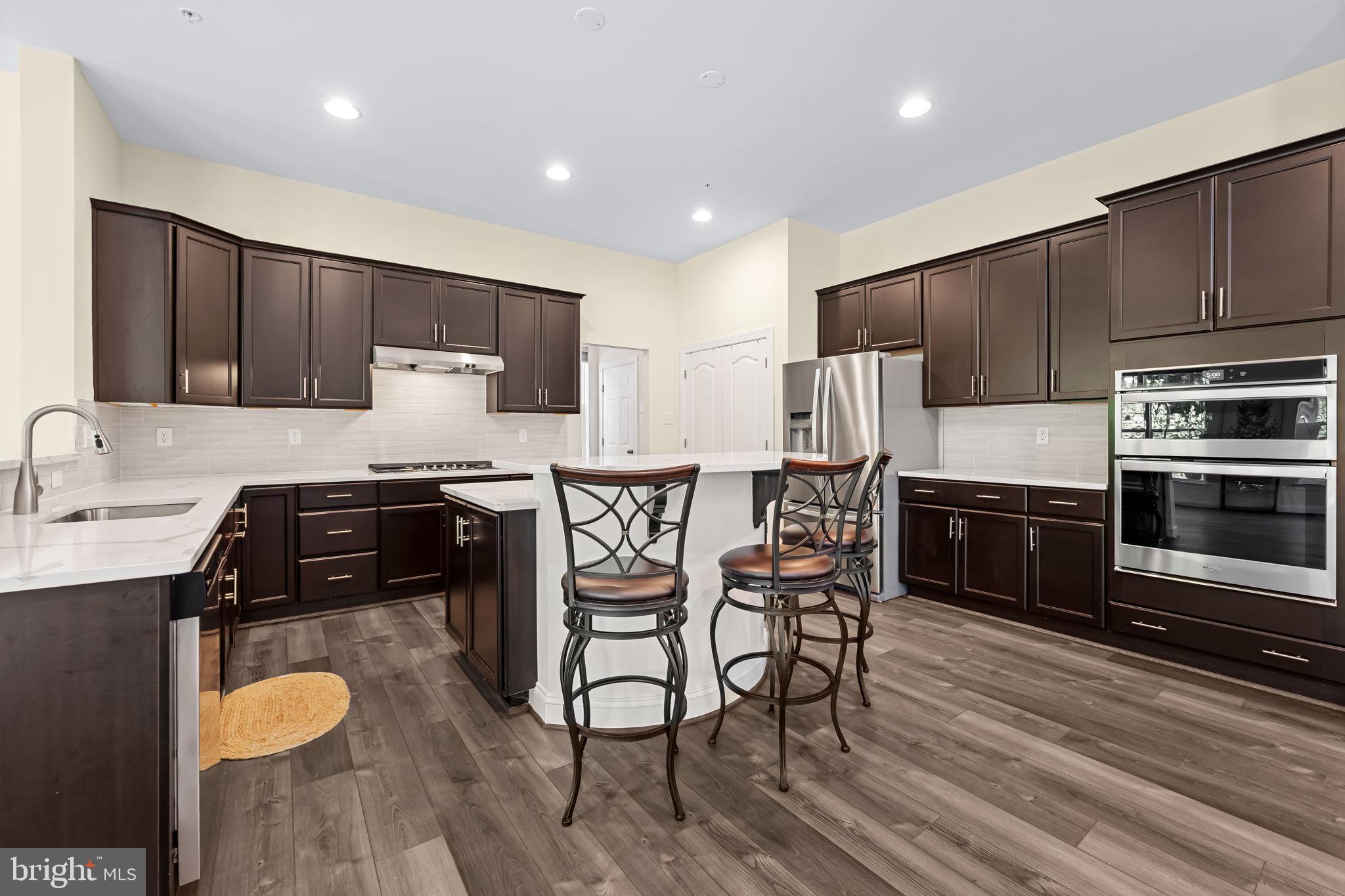 6352 Islington Street Middle River, MD 21220 - Photo 18 of 58 a kitchen with stainless steel appliances a stove a sink a microwave a refrigerator and cabinets