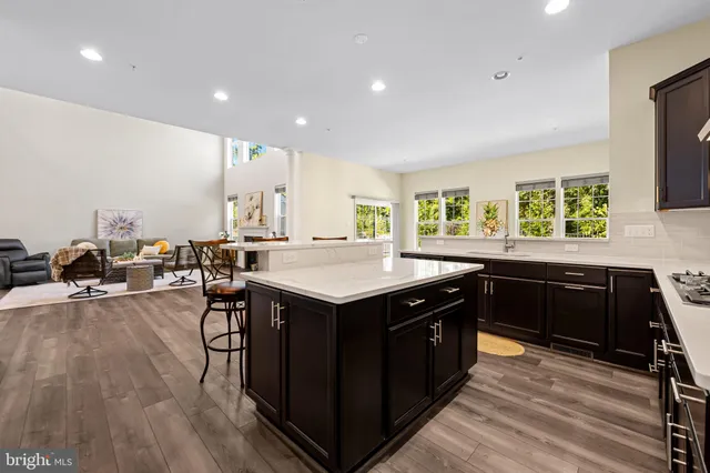 a kitchen with stainless steel appliances sink a stove and cabinets
