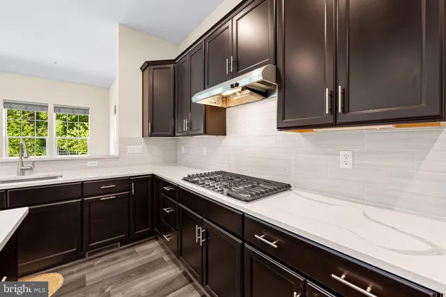 a kitchen with a sink and stove