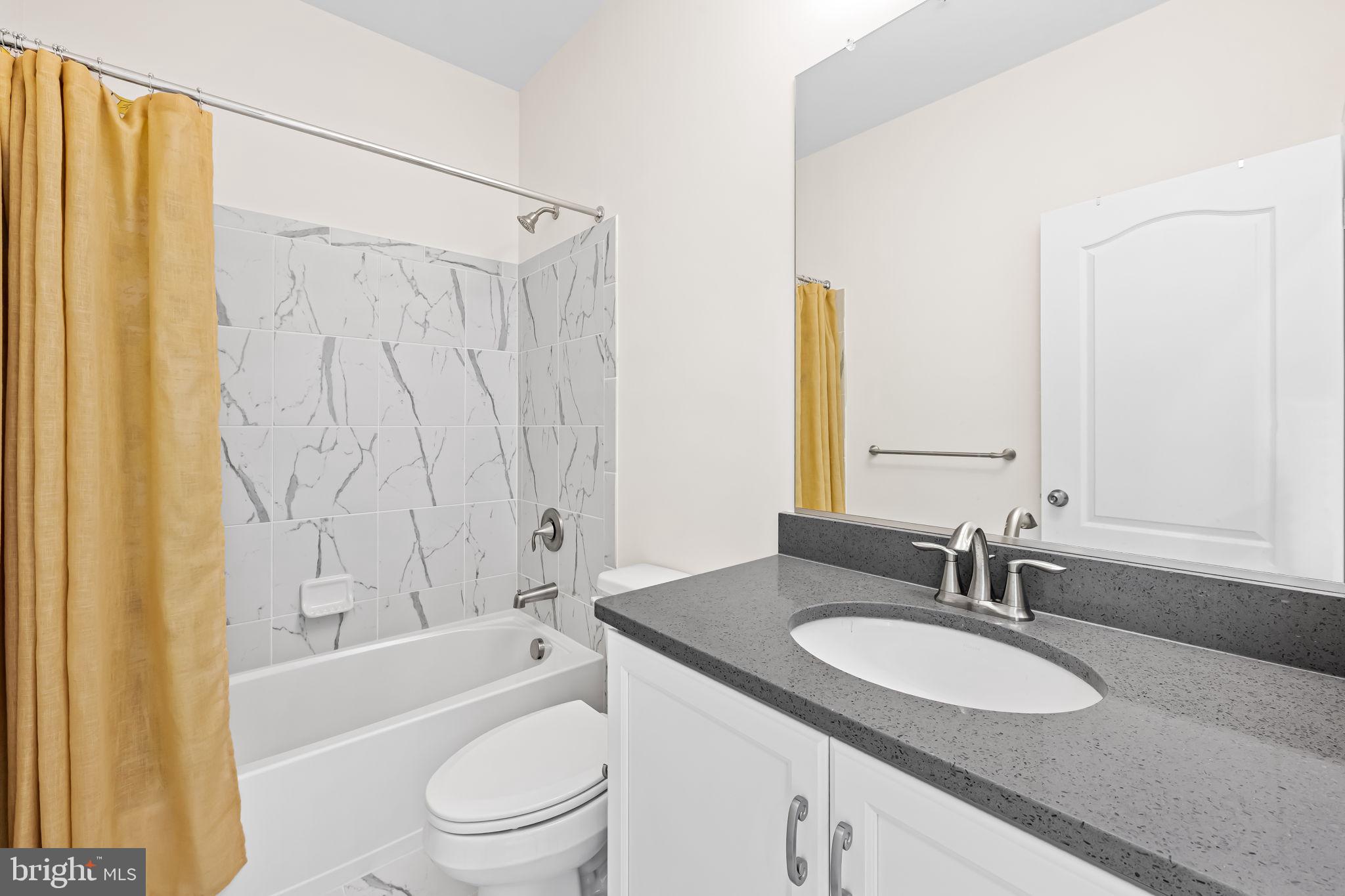 6352 Islington Street Middle River, MD 21220 - Photo 30 of 58 a bathroom with a granite countertop sink a toilet and shower