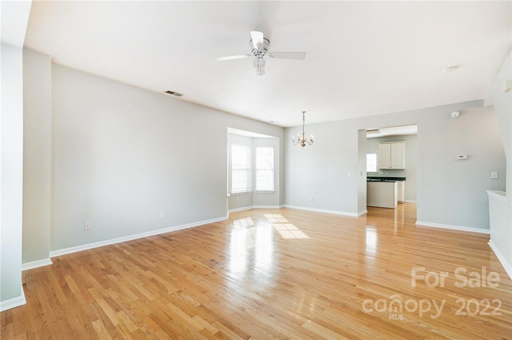 144 Rock Ridge Lane Mount Holly, NC 28120 - Photo 11 of 48 a view of empty room with wooden floor and fan