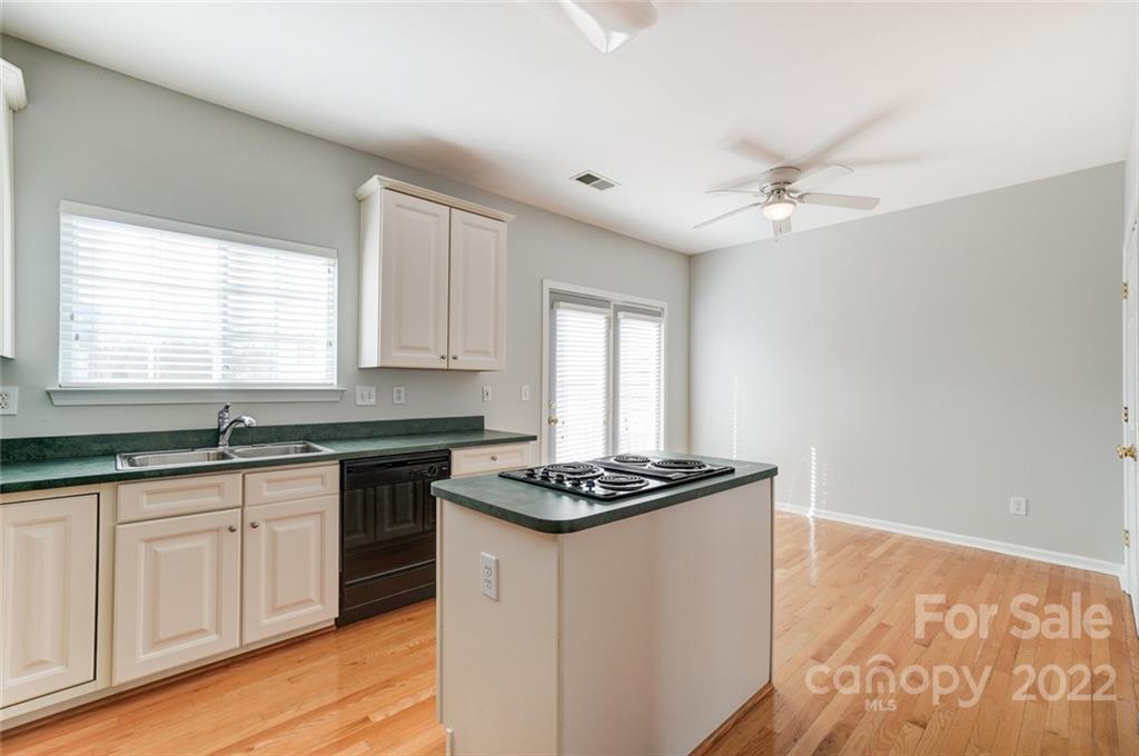 144 Rock Ridge Lane Mount Holly, NC 28120 - Photo 15 of 48 a kitchen with granite countertop stainless steel appliances a sink stove and cabinets
