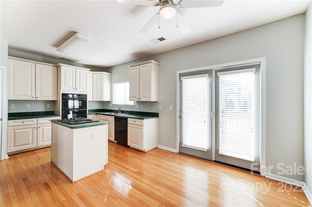 144 Rock Ridge Lane Mount Holly, NC 28120 - Photo 17 of 48 a kitchen with a refrigerator a sink and white cabinets