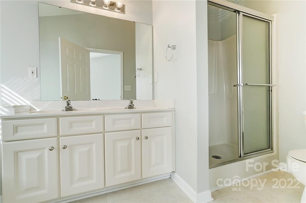 144 Rock Ridge Lane Mount Holly, NC 28120 - Photo 26 of 48 a bathroom with a shower sink and mirror