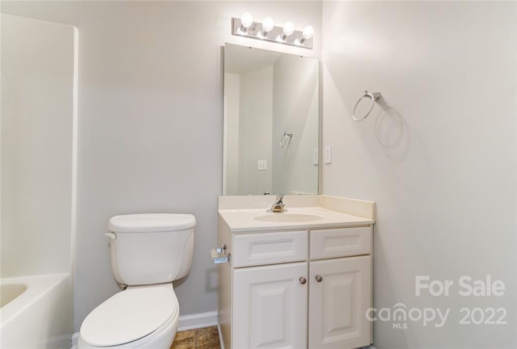 144 Rock Ridge Lane Mount Holly, NC 28120 - Photo 34 of 48 a bathroom with a toilet a sink and mirror