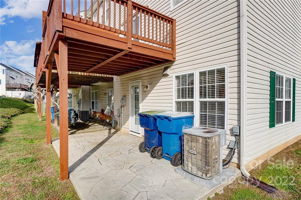 144 Rock Ridge Lane Mount Holly, NC 28120 - Photo 43 of 48 a view of a patio with table and chairs with wooden fence and plants
