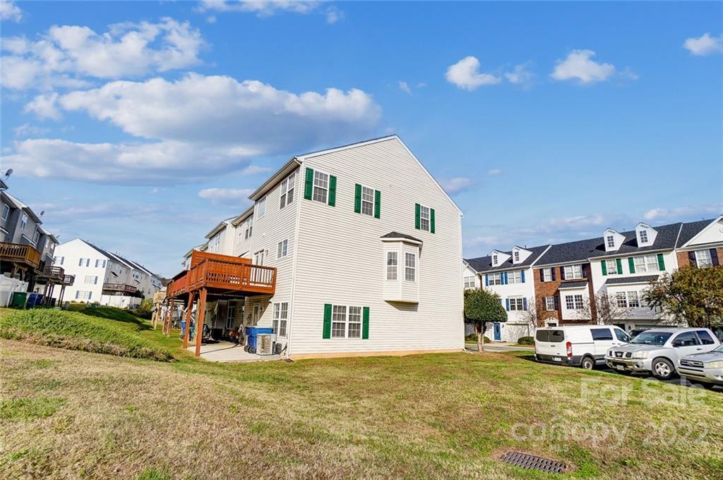 144 Rock Ridge Lane Mount Holly, NC 28120 - Photo 46 of 48 a view of a big house with a patio and a yard