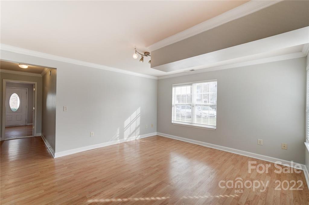 144 Rock Ridge Lane Mount Holly, NC 28120 - Photo 5 of 48 a view of an empty room with wooden floor and a window