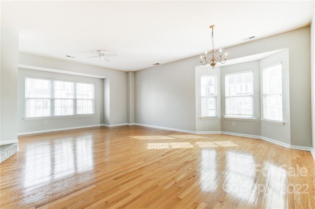 144 Rock Ridge Lane Mount Holly, NC 28120 - Photo 10 of 48 a view of an empty room with a window and wooden floor