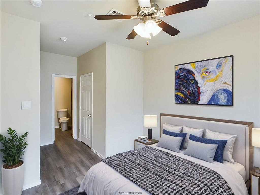 2910 Town Square Avenue, Unit 2608 Bryan, TX 77802 - Photo 6 of 8 a bedroom with a large bed and a chandelier
