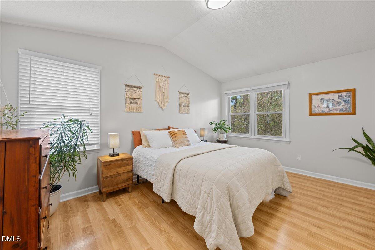 501 Darby Glen Lane Durham, NC 27713 - Photo 16 of 25 a bedroom with bed and a large window