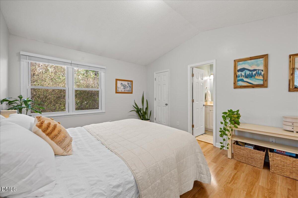 501 Darby Glen Lane Durham, NC 27713 - Photo 17 of 25 a bedroom with a bed and a table