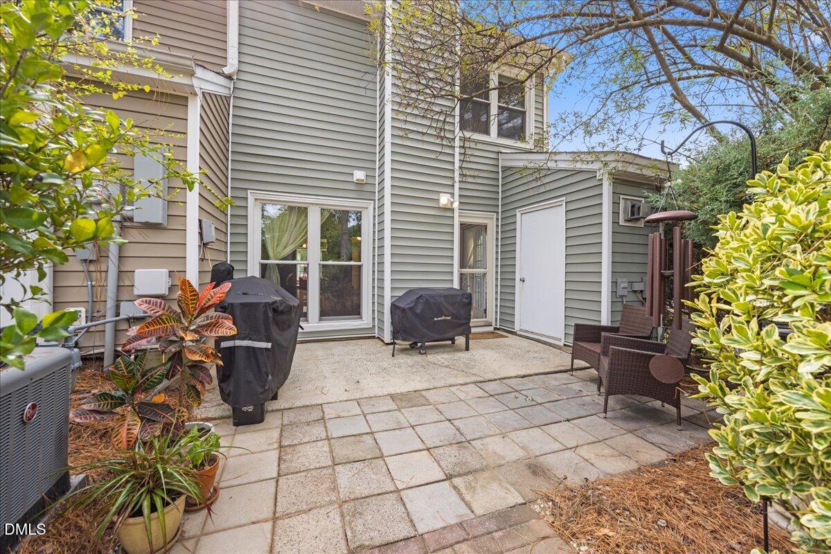 501 Darby Glen Lane Durham, NC 27713 - Photo 22 of 25 a view of a chair and tables in the back yard of the house