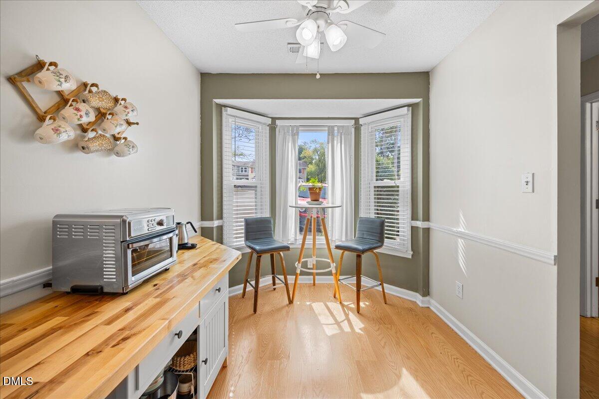 501 Darby Glen Lane Durham, NC 27713 - Photo 5 of 25 a dining room with wooden floor and chandelier