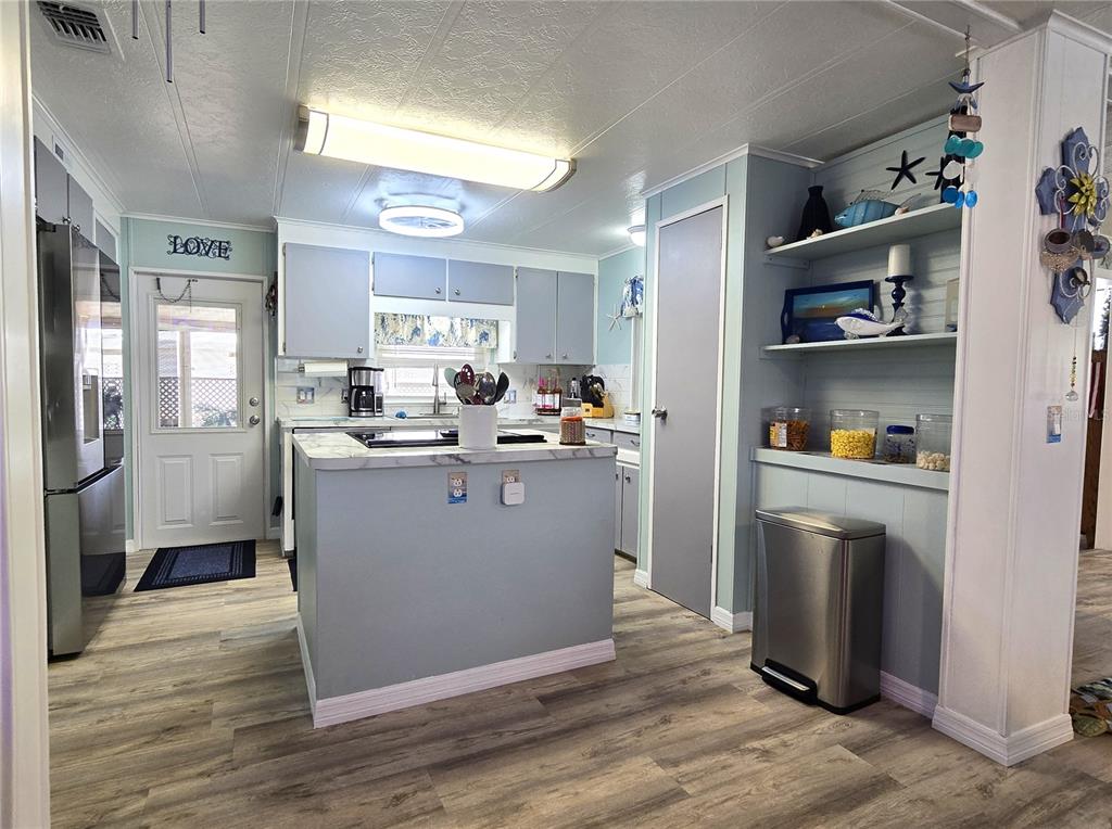 5619 Bayshore Road, Unit 435 Palmetto, FL 34221 - Photo 15 of 56 a room with stainless steel appliances granite countertop a refrigerator a sink a stove and cabinets