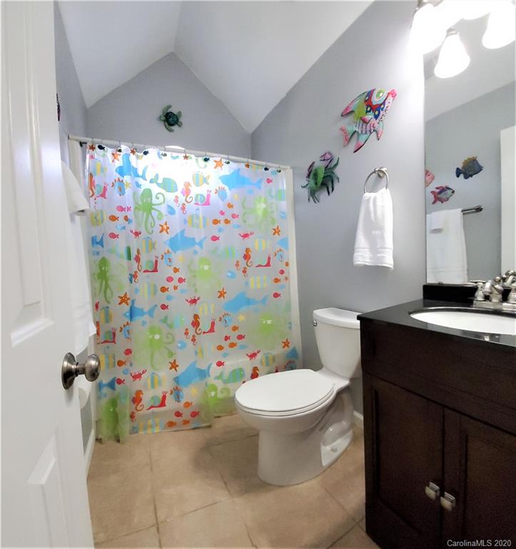 7213 Reedy Creek Road Charlotte, NC 28215 - Photo 22 of 33 a bathroom with a sink mirror vanity and toilet