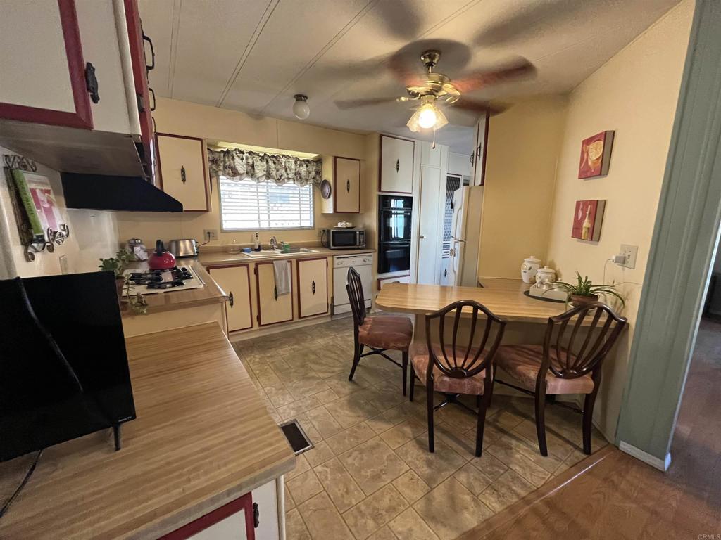 1810 Hillsdale Road, Unit 99 El Cajon, CA 92019 - Photo 1 of 15 a view of a dining room with furniture and a chandelier