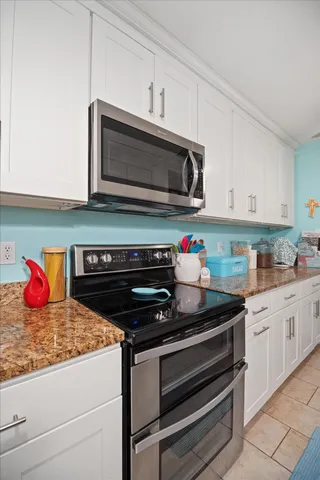 a bedroom with a bed a dresser and next to a window