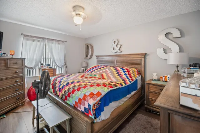 a bedroom with a bed and a dresser in it