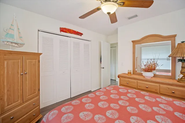 a bathroom with a granite countertop toilet sink and mirror