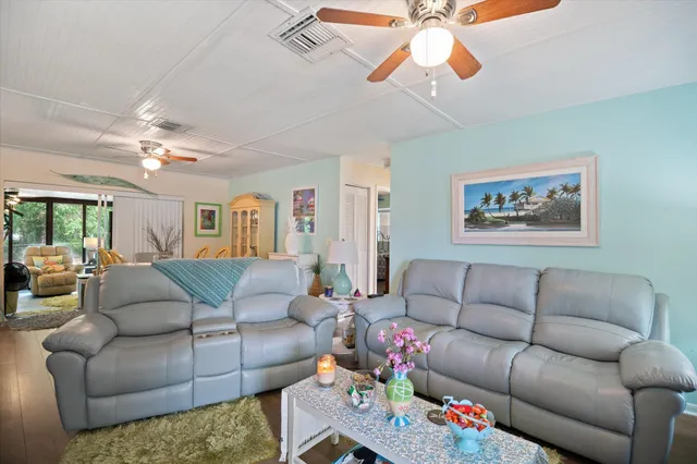 a living room with furniture a chandelier and a couch