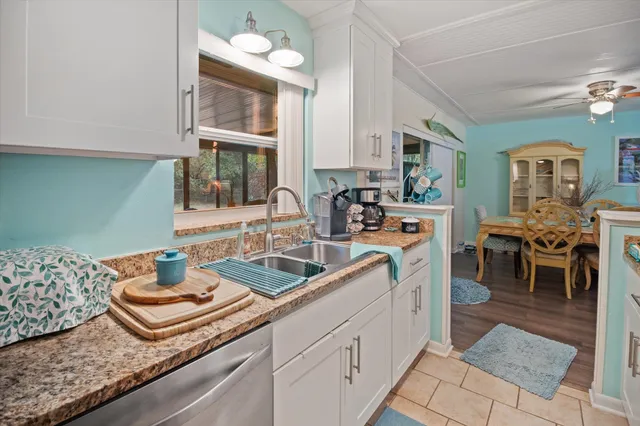 a kitchen with stainless steel appliances granite countertop a stove and cabinets