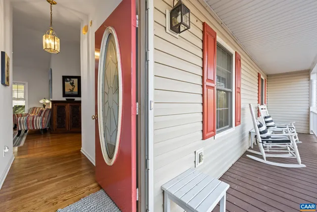 a living room with furniture fireplace and a large window