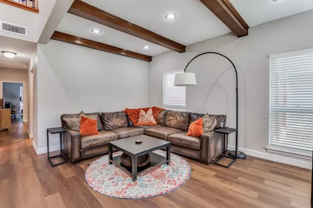 a living room with furniture and wooden floor