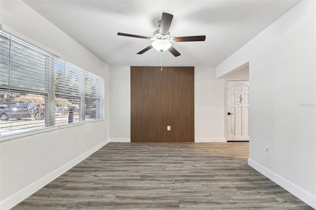 4706 Catherine Street New Port Richey, FL 34652 - Photo 11 of 45 a view of an empty room with wooden floor and a window