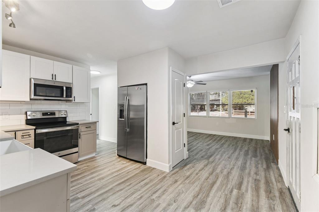 4706 Catherine Street New Port Richey, FL 34652 - Photo 13 of 45 a kitchen with wooden floors and appliances