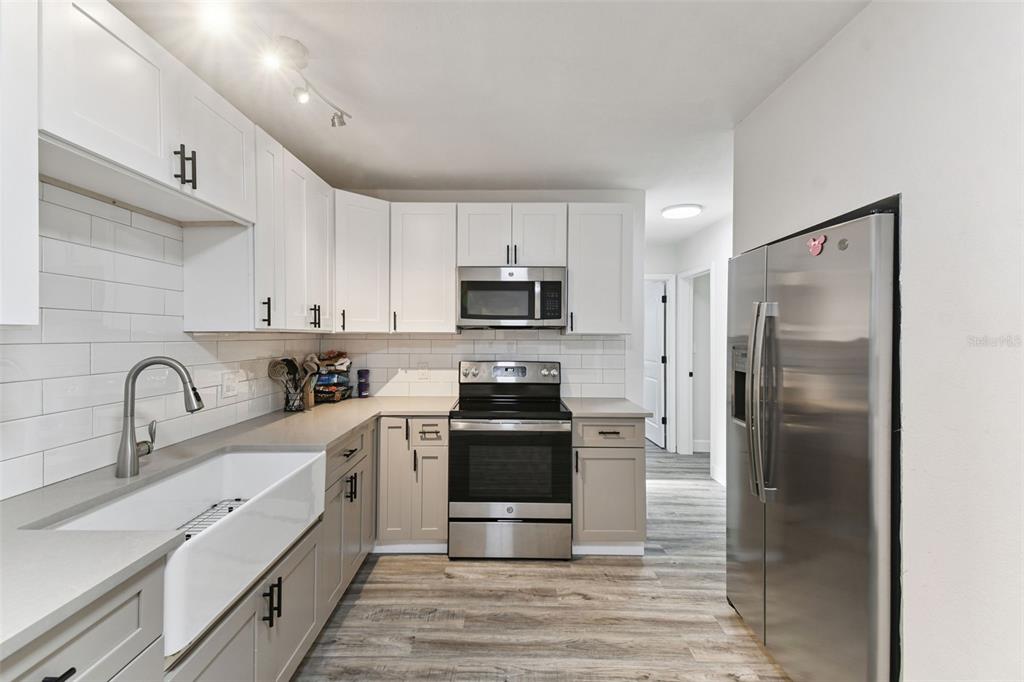 4706 Catherine Street New Port Richey, FL 34652 - Photo 15 of 45 a kitchen with a sink stainless steel appliances and cabinets